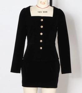 Close-up of black velvet square neck top with decorative gold embossed buttons