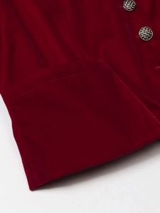Detailed macro view of burgundy velvet blazer fabric with engraved metal button and pockets