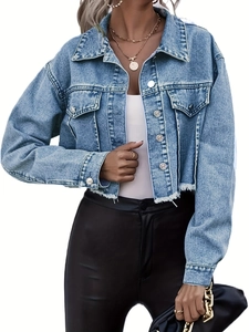 Detail of light blue denim jacket featuring raw hem, metal buttons and chest pockets