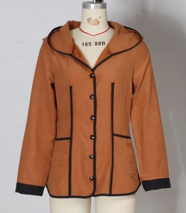 Detail view of terracotta hooded jacket featuring black buttons and contrast trim stitching