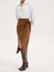 Elegant brown suede wrap skirt for women featuring high waist tie knot and asymmetrical slit
