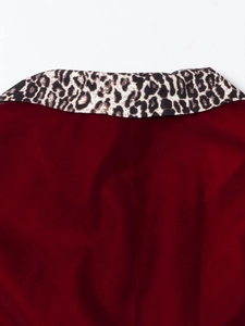 Detail of burgundy velvet suit collar featuring a trendy leopard print fabric contrast