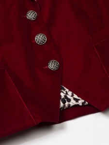 Detail of burgundy velvet blazer featuring silver textured buttons and leopard print lining