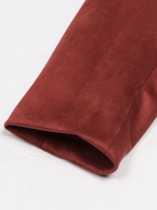 Detail of rust red suede blazer cuff showing premium texture and neat stitching