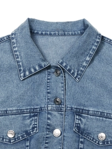 Women's light blue denim jacket featuring silver metal buttons and chest pockets