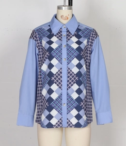 Close-up of patchwork diamond pattern and button-down collar on blue long sleeve blouse