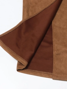 Detailed macro shot of brown suede fabric showing precise stitching and smooth inner lining