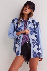 Detail of French casual blouse featuring blue and white diamond geometric patchwork sleeves