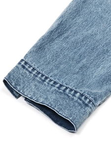 Close-up of light blue denim cuff showing detailed texture and quality stitching