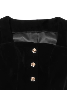 Detail of square neckline on black velvet top with three ornate golden buttons