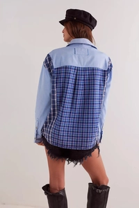 Detail of light blue long sleeve shirt featuring a contrast checkered patchwork on the back