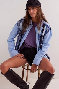 Close-up of blue patchwork shirt featuring diamond pattern and long sleeves for women