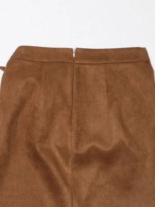 Detail of high-waist brown suede skirt with hidden back zipper and tailored darts