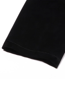 Close-up of premium black velvet fabric showing detailed texture and fine stitching lines