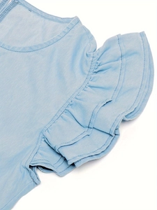 Detailed view of layered ruffle cuffs and denim fabric texture on light blue dress