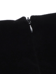 Detailed view of an invisible silver metal zipper on premium black velvet fabric material