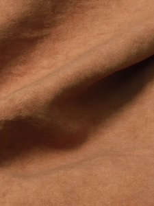 Macro detail of the premium orange-red fleece fabric texture and woven knit structure