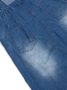 Detail of dark blue denim dress showing back pockets, double stitching and washed texture