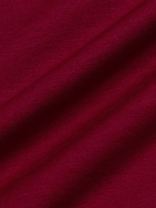 Macro shot of dark burgundy knitted fabric texture with horizontal ribbing
