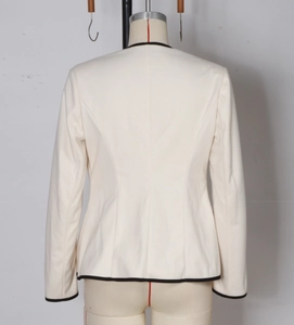 Detailed back view of a slim-fit cream blazer with black contrast trim and structured seams