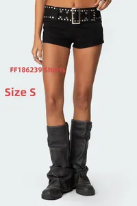 Detail of black slim-fit hot pants with studded leather belt and high boots in punk style
