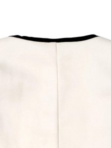 Detail of cream blazer with black contrast trim and high-quality wool texture finish