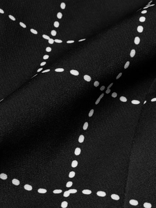 Close-up of black and white houndstooth pattern on a slim fit women blazer jacket