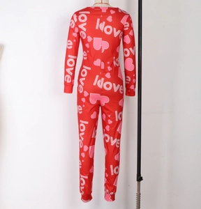 Close-up of red slim fit jumpsuit with white love letters and pink heart patterns