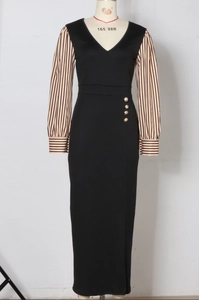 Detail of V-neck long dress with striped sleeves, gold buttons, and a side leg slit
