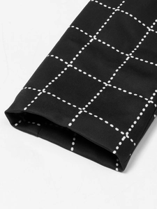 Close-up of houndstooth plaid pattern and premium stitching on women's blazer sleeves