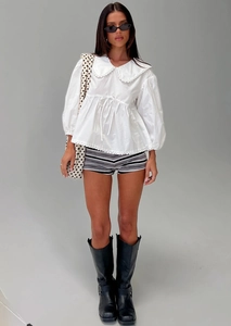 Detail of white cotton blouse showing delicate lace-edged Peter Pan collar and waist drawstring