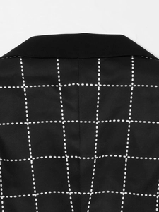 Detailed close-up showing the lapel and dot grid pattern of the black blazer jacket