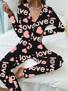 Detailed view of black slim-fit romper with pink heart and love print on soft fabric