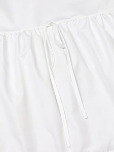 Close-up of lace collar blouse with delicate drawstring tie and pleated fabric detail
