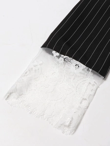 Chic black pinstripe dress featuring elegant white floral lace sleeves and eyelash trim