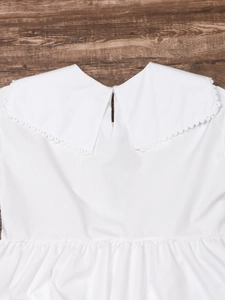 Close-up of a white Peter Pan collar with delicate lace trim on a long sleeve shirt