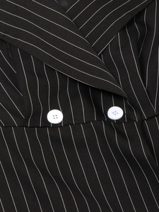 Close-up of lapel collar and white buttons on black pinstripe lace patchwork dress