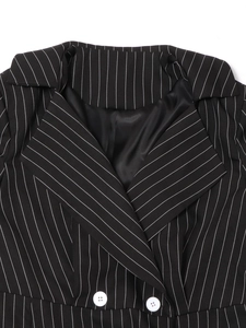 Detailed macro view of black pinstripe blazer collar with white buttons and silk lining