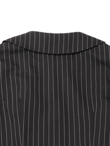 Close-up of black pinstripe fabric texture on the back collar of the lace patchwork dress