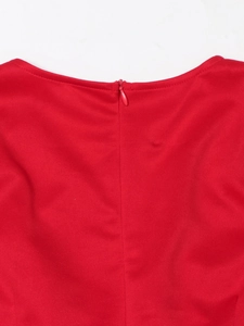 Detailed view of invisible back zipper on red elegant high-waist evening dress