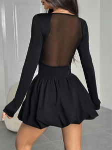 Detail view of the elegant black bubble dress featuring mesh sheer back stitching and puff hem