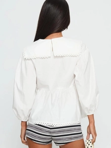 Women's white puff sleeve blouse featuring a large lace-trimmed collar and back detail