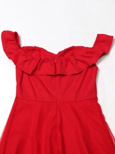 Detailed view of red off-shoulder dress featuring ruffle neckline and mesh patchwork