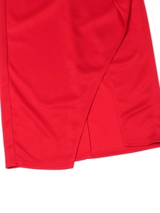 Detail of red high-waist evening dress featuring elegant overlap slit and premium fabric