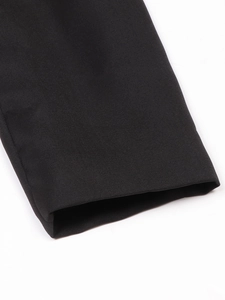 Detail of premium black twill fabric texture and fine stitching on formal dress sleeve