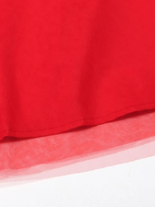 Detail of red evening dress showing the layered structure of solid fabric and fine tulle