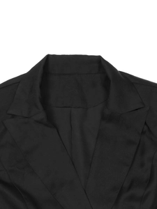 Detail view of notched lapel and woven fabric texture on a black long sleeve blazer dress