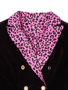 Detail of leopard print lapel and embossed gold buttons on purple velvet blazer