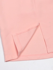 Detail view of the elegant pink dress hem featuring a side slit and reinforced stitching