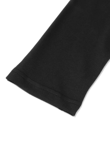 Detailed close-up of double-needle stitched cuffs on black knitted puff sleeve dress